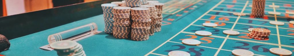 Casino table with various stack of poker chips and gambling elements, depicting a gaming environment.