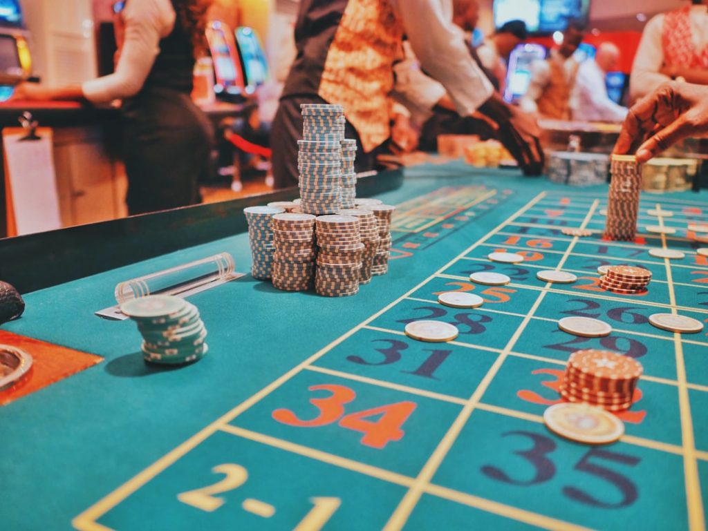 Casino table with various stack of poker chips and gambling elements, depicting a gaming environment.